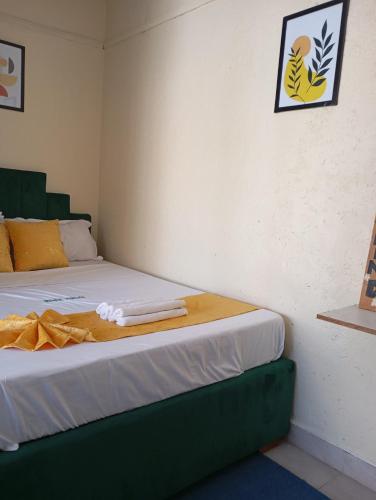a bedroom with a bed with a blanket on it at Milele studio bnb in Nakuru