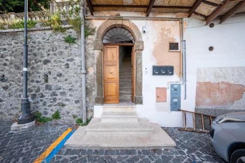 an entrance to a building with a wooden door at Al Belvedere A cozy with hills and village view in Rocca di Papa