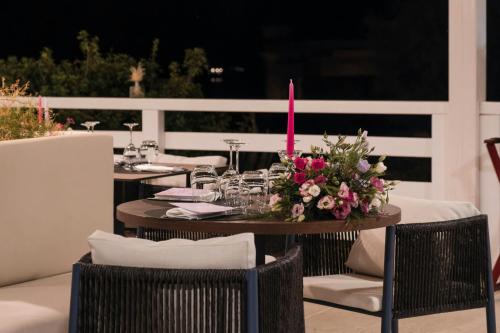 a table with a flower arrangement on a patio at Mangia's Brucoli, Sicily, Autograph Collection in Brucoli