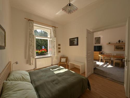 a bedroom with a bed and a dining room at U Bílého Beránka in Děčín