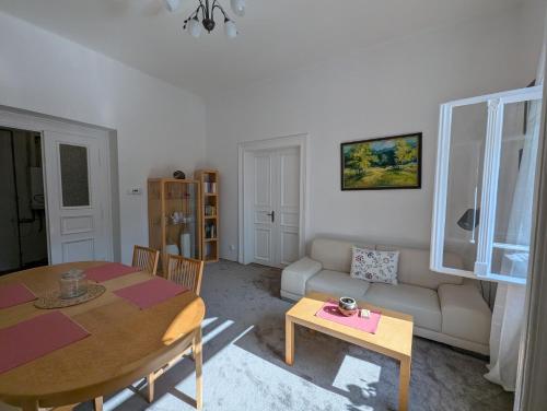 a living room with a table and a couch at U Bílého Beránka in Děčín