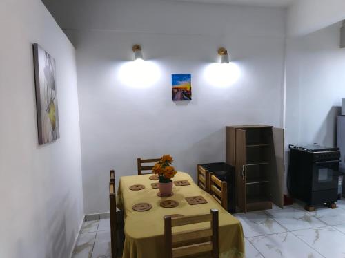 a dining room with a table and a tv at Accra City Studios & Apartment in Accra