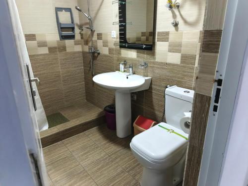 a bathroom with a toilet and a sink at Accra City Studios & Apartment in Accra