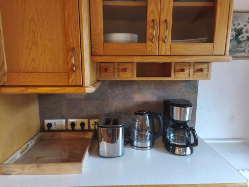 a kitchen counter with two coffee makers on a counter top at Sport Apartments Tirol in Umhausen