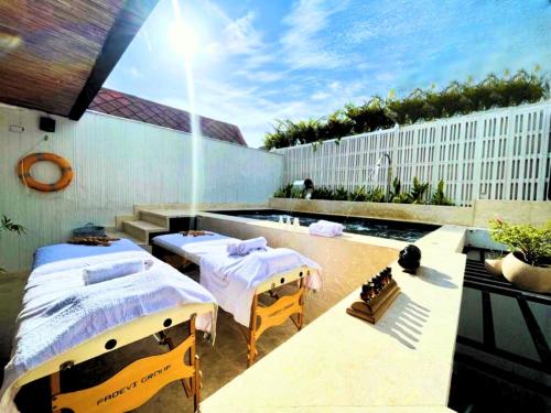 a rooftop patio with two beds and a pool at Casa Bugó Arsenal Hotel Boutique en Getsemaní in Cartagena de Indias