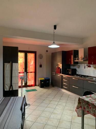 a large kitchen with a table and a dining room at Tana per gli ospiti in Terni