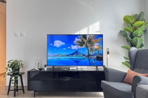 a living room with a flat screen tv on a wall at Elegant 4BR - Stylish Pearl Edge Escape in Abu Dhabi