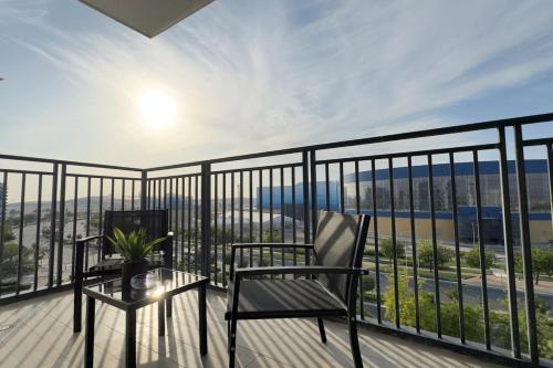 a balcony with a chair and a table and a view at Elegant 4BR - Stylish Pearl Edge Escape in Abu Dhabi