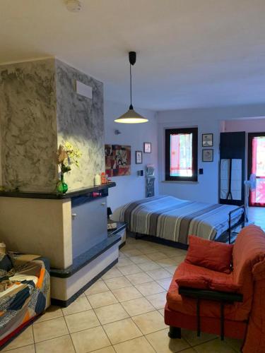 a bedroom with a bed and a couch and a chair at Tana per gli ospiti in Terni