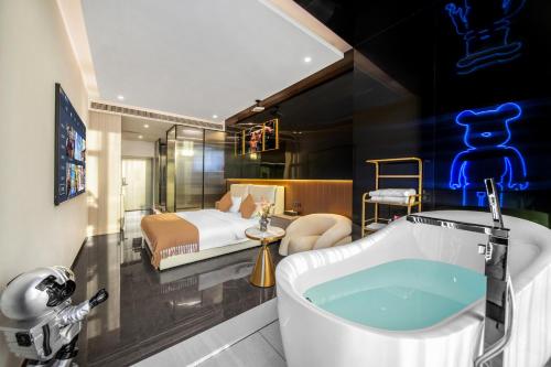 a hotel room with a tub and a bedroom at Ouchen International Hotel Chongqing Guanyinqiao Pedestrian Street Branch in Chongqing
