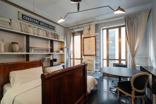 a bedroom with a bed and a desk and a table at Milano Artist Apartment in Milan