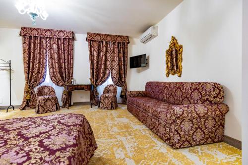 a living room with a couch and a bed at Hotel Giorgione in Venice