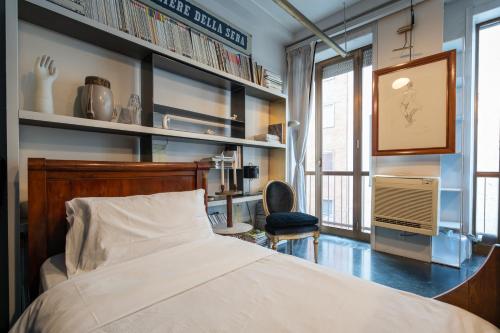 a bedroom with a bed and a desk and a chair at Milano Artist Apartment in Milan