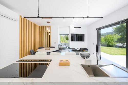 a living room with a table and a couch at La Casa Del Rio in Kymi