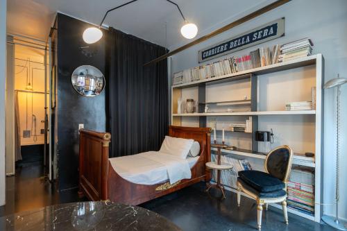 a bedroom with a bed and a desk and a chair at Milano Artist Apartment in Milan
