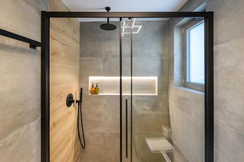 a shower with a glass door in a bathroom at La Casa Del Rio in Kymi