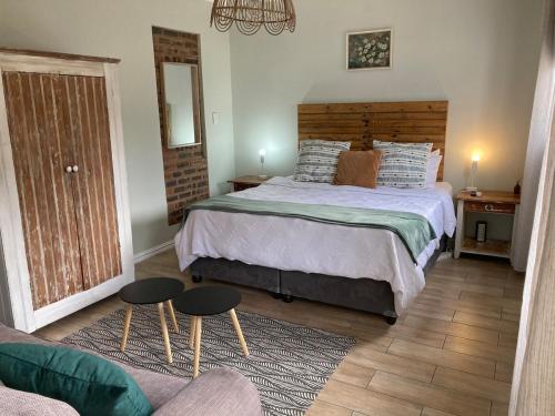 a bedroom with a large bed with two tables at Studio Room Durban North in Durban
