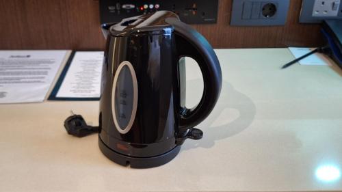 a black coffee pot sitting on a table at Radisson Blu Hotel, Addis Ababa in Addis Ababa