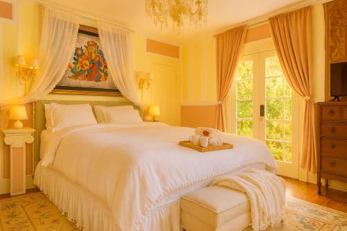 a bedroom with a large bed with a teddy bear on a tray at Luxe Homestay in Hollywood - by The Grove & Walk of Fame in Los Angeles