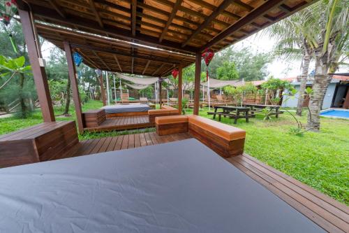 an outdoor patio with a couch and a table at Hoianbang Beach Front Villa and Restaurant in An Bang