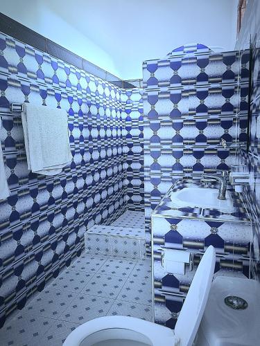 a bathroom with a toilet and a sink at Sweet Home in Kiwengwa
