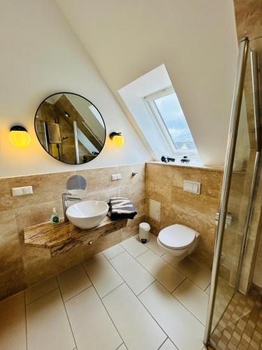 a bathroom with a sink and a mirror at Wohnung Hafenblick in Zingst