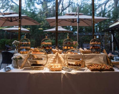 a table with a buffet of food in bird cages at Swiss Lenana Mount Hotel in Nairobi
