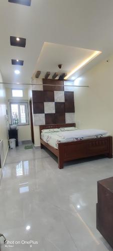 a bedroom with a bed in the middle of a room at Archana palace hampi in Hampi
