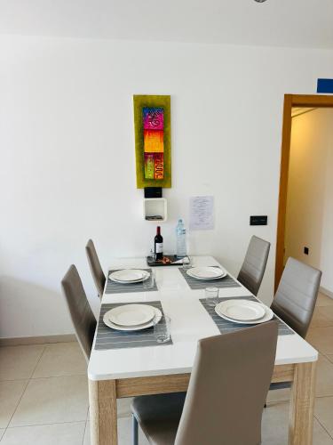 a dining room with a table and chairs with plates on it at Malpais in Puertito de Güímar