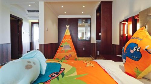 a bedroom with a bed with a toy pyramid on it at Wyndham Garden Wenchang Nanguo in Wenchang