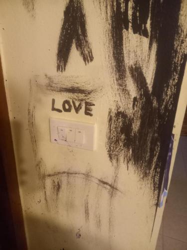 a wall with a drawing of a person on it at Sweden Inn Hostel Chalong in Ban Klang