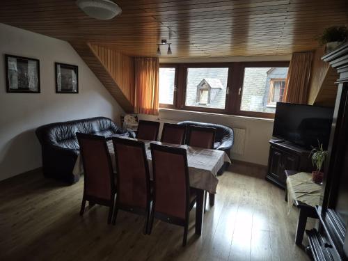 a living room with a table and chairs and a couch at Haus Sofia in Cochem