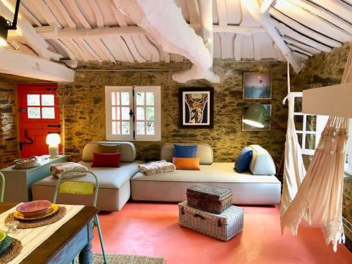 a living room with a couch and a table at The Cliffs - Cala Porto do Val in O Vicedo