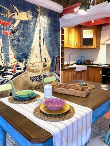 a kitchen with a table with plates on it at The Cliffs - Cala Porto do Val in O Vicedo