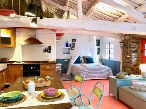 a kitchen and living room with a bed and a table at The Cliffs - Cala Porto do Val in O Vicedo