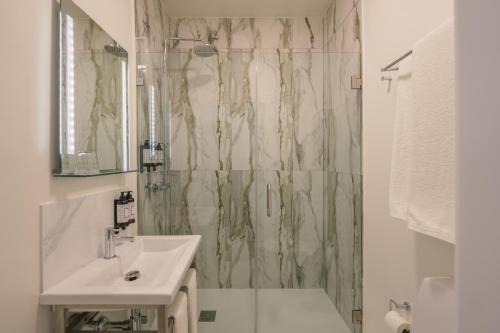 a bathroom with a sink and a shower at Solar dos Poetas in Lisbon