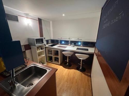 a small kitchen with a sink and a stove at La Serra Olivetti in Ivrea