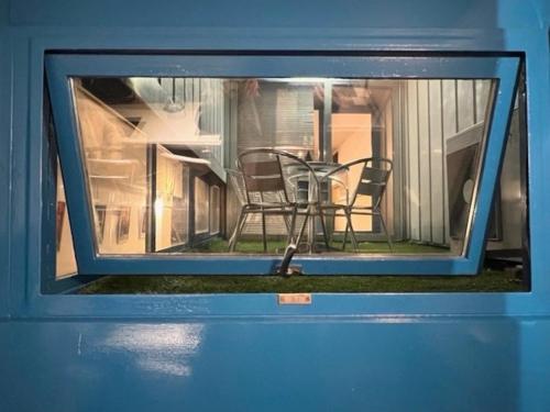 a window in a house with a table and chairs at La Serra Olivetti in Ivrea