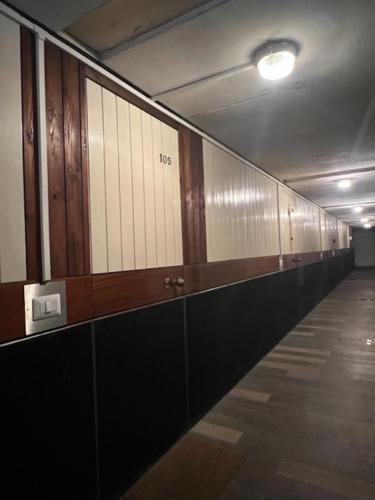 a hallway with a row of lockers in a building at La Serra Olivetti in Ivrea