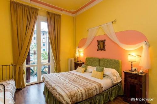 a bedroom with a bed and a large window at Viareggio Old Style Sea View in Viareggio