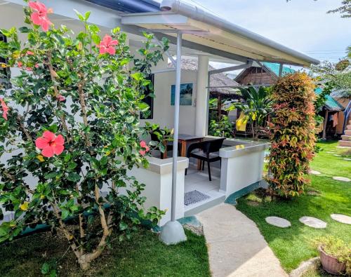 a view of a house with a garden at Astillo's Guest Houses in Moalboal