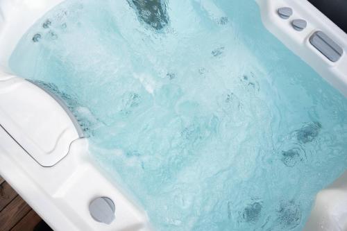 a bath tub with blue water in it at Bierhotel in Oberstdorf
