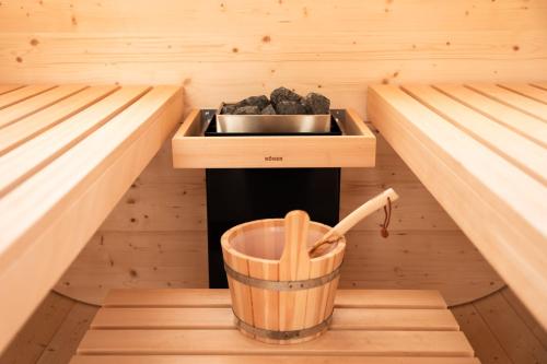 a kitchen in a sauna with a bowl of rocks at Bierhotel in Oberstdorf