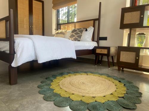 a bedroom with a bed with a rug on the floor at Aesthetic Apartment in NorthGoa in Siolim