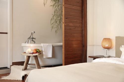 a bedroom with a bed and a bath tub at Lijiang Sadhu Inn in Lijiang