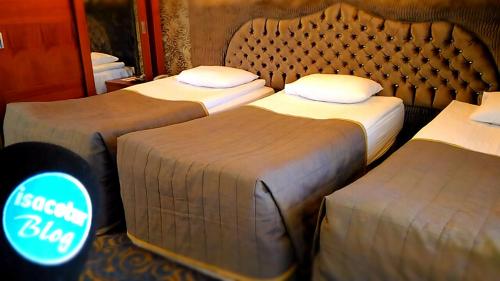 a hotel room with two beds and a sign that says secret bug at TAC MAHAL HOTEL in Ankara