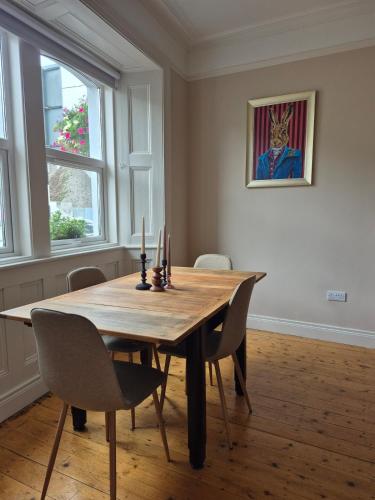 a dining room with a wooden table and chairs at Entire home sleeps 8 in Cloghjordan