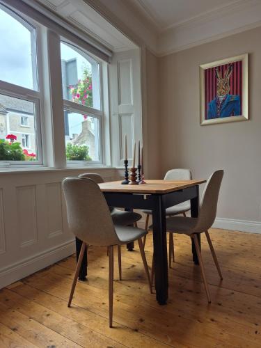 a dining room with a table and chairs and windows at Entire home sleeps 8 in Cloghjordan