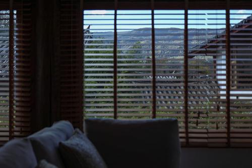 a living room with a large window looking out at a city at Lijiang Sadhu Inn in Lijiang