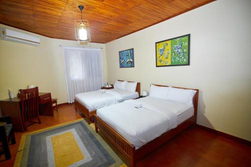 Postel nebo postele na pokoji v ubytování The Haven Boutique Hotel